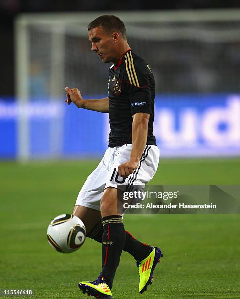 Lukas Podolski of Germany runs with the ball during the UEFA EURO 2012 qualifying match between Azerbaijan against Germany at Tofig-Bahramov-Stadium...