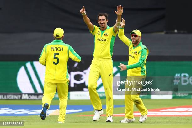 Mitchell Starc of Australia celebrates with Aaron Finch and David Warner after taking the wicket on review of Wahab Riaz during the Group Stage match...