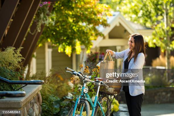 kvinna som använder en cykel för att springa ärenden - buying a bike bildbanksfoton och bilder