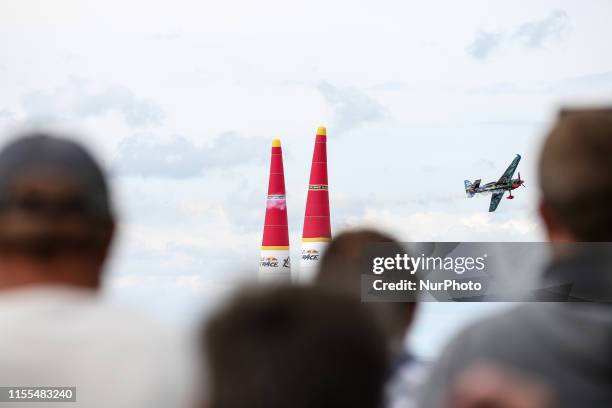 Spectators watch as Petr Kopfstein from Czech Republic, Team Spielberg competes in Masters Class qualification of Red Bull Air Race at Lake Balaton,...