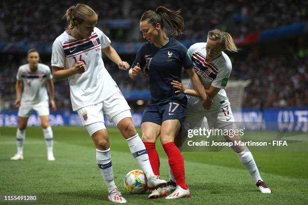 Gaetane Thiney of France is challenged by Guro Reiten and Kristine Minde of Norway during the 2019 FIFA Women's World Cup France group A match...