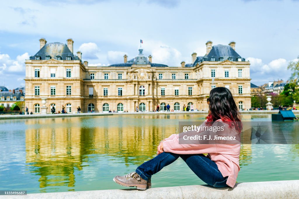 Woman looking towards the Luxembourg Palace in the Luxembourg Gardens, Paris