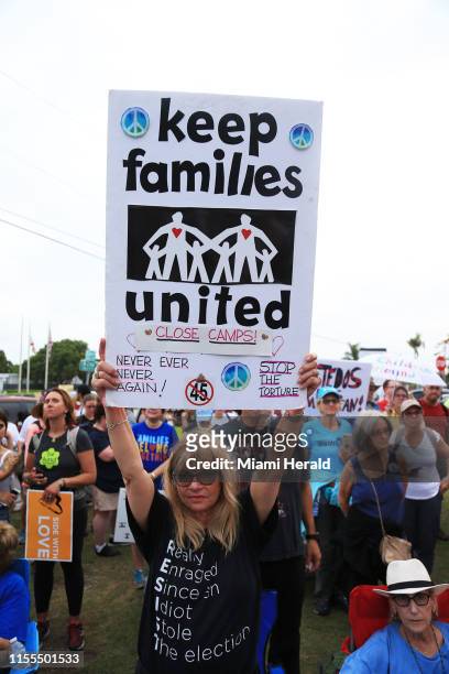 Suzy Feldman holds a sign while protesting outside the child detention facility in Homestead, Fla., on July 12, 2019.