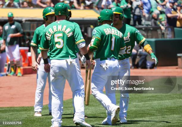 Oakland Athletics second baseman Franklin Barreto is greeted by Oakland Athletics catcher Chris Herrmann and Oakland Athletics center fielder Ramon...