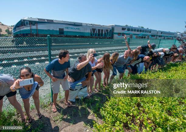 Residents of Laguna Niguel expose their buttocks to a passing Metrolink train during the annual "Mooning of the trains" event along a stretch of...