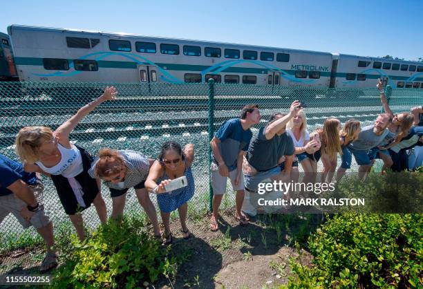 Residents of Laguna Niguel expose their buttocks to a passing Metrolink train during the annual "Mooning of the trains" event along a stretch of...