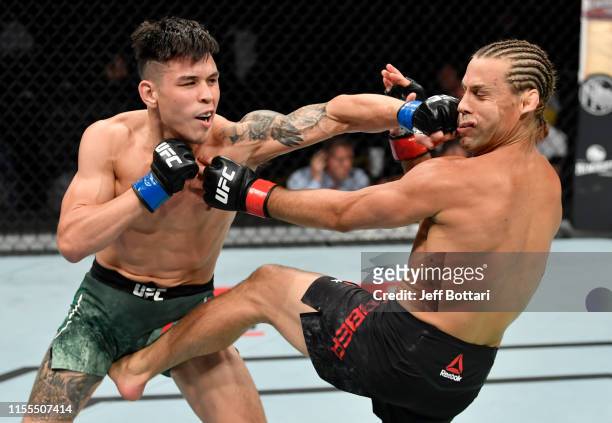 Ricky Simon punches Urijah Faber in their bantamweight bout during the UFC Fight Night event at Golden 1 Center on July 13, 2019 in Sacramento,...