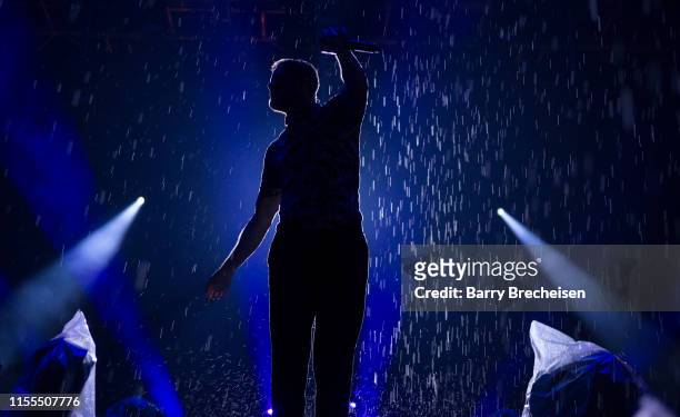 Dan Reynolds of Imagine Dragons performs in the rain shortly before the show was cancelled due to weather conditions, at the Festival d'été de Québec...