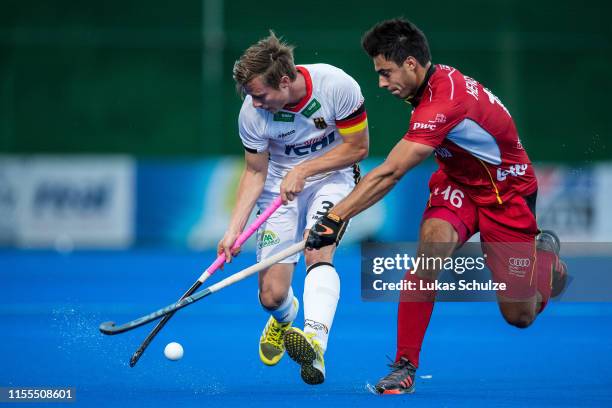 Mats Grambusch of Germany challenges for the ball with Alexander Hendickx of Belgium during the Men's FIH Field Hockey Pro League match between...