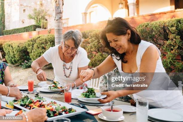 senior friends at garden party reunion - mexican food party stock pictures, royalty-free photos & images