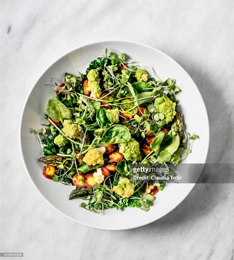 A bowl of fresh salad on white background