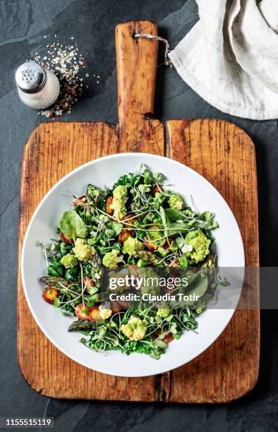 a bowl of fresh salad on black background - watercress stock pictures, royalty-free photos & images