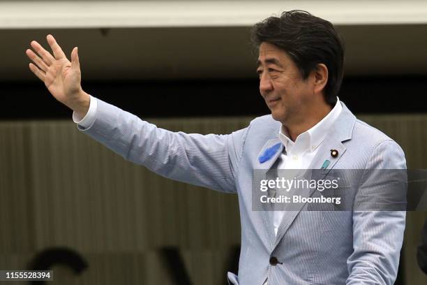 Shinzo Abe, Japan's prime minister and president of the Liberal Democratic Party , waves to supporters during an election campaign rally in Kobe,...