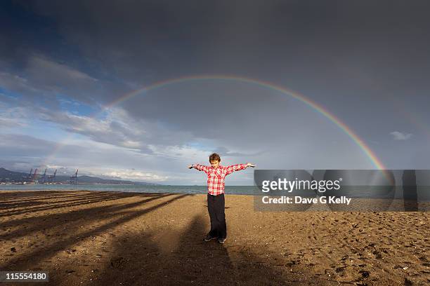 boy standing on beach - dubbel regnbåge bildbanksfoton och bilder