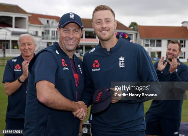 Ollie Robinson of England Lions is presented with his first cap by Marcus Trescothick before the England Lions v Australia A match at The Spitfire...