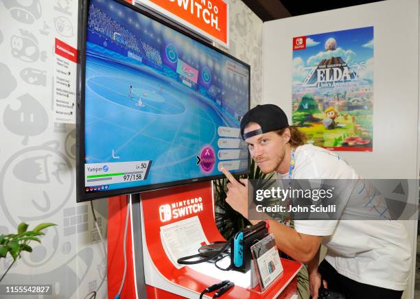 Blake Anderson checks out 'Pokémon Sword and Pokémon Shield' for the Nintendo Switch system during the 2019 E3 Gaming Convention at Los Angeles...