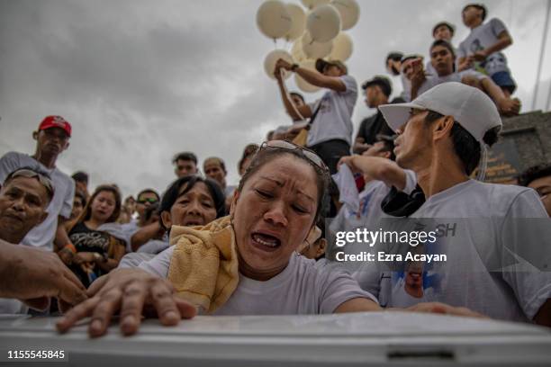 Terese Conje weeps at the coffin of her son Bryan Conje during his funeral on July 14, 2019 in Navotas, Metro Manila, Philippines. According to...