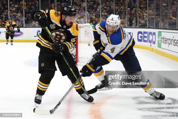 Carl Gunnarsson of the St. Louis Blues and Brad Marchand of the Boston Bruins vie for position during the third period of the 2019 NHL Stanley Cup...