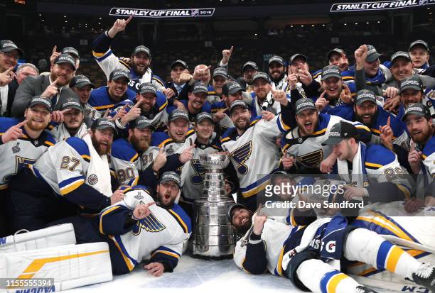 The St. Louis Blues pose for a photo with the Stanley Cup on the ice after the 2019 NHL Stanley Cup Final at TD Garden on June 12, 2019 in Boston,...