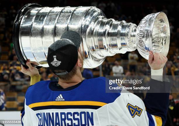 Carl Gunnarsson of the St. Louis Blues kisses the Stanley Cup on the ice after the 2019 NHL Stanley Cup Final at TD Garden on June 12, 2019 in...