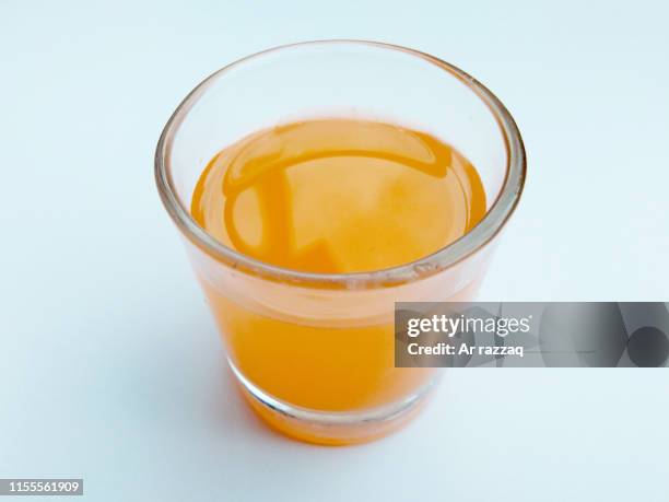 orange juice with a white background - orange juice glass white background stock-fotos und bilder