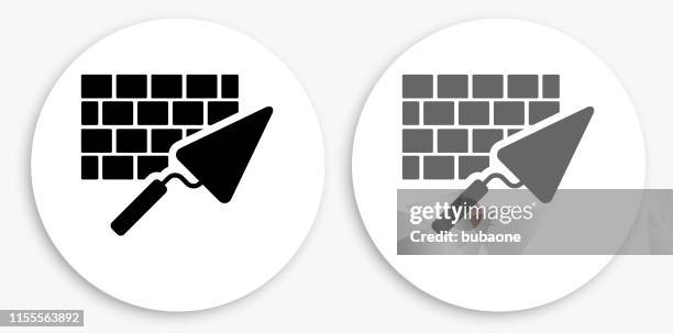 brick and mortar black and white round icon - trowel stock illustrations