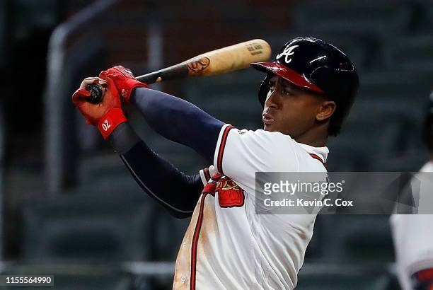 Ozzie Albies of the Atlanta Braves hits a walk-off double in the 11th inning against the Pittsburgh Pirates at SunTrust Park on June 12, 2019 in...