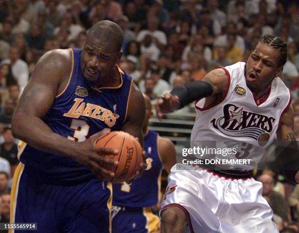 Los Angles Lakers center Shaquille O'Neal pulls the ball away from Philadelphia 76ers guard Allen Iverson during the second quarter of game four of...