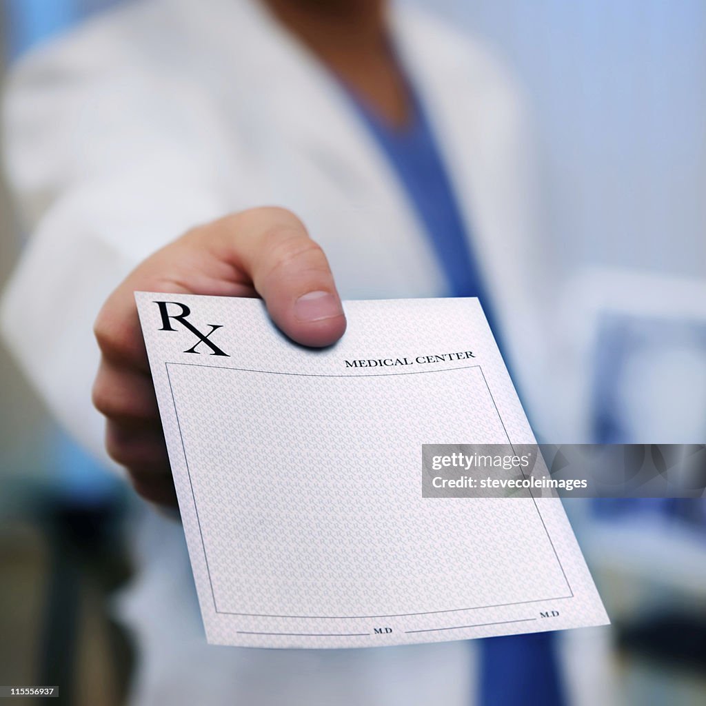 Doctor's Hand holding Prescription Pad