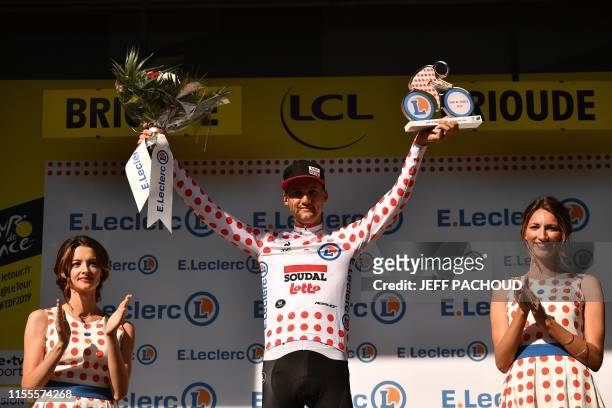 Belgium's Tim Wellens celebrates his best climber's polka dot jersey on the podium of the ninth stage of the 106th edition of the Tour de France...