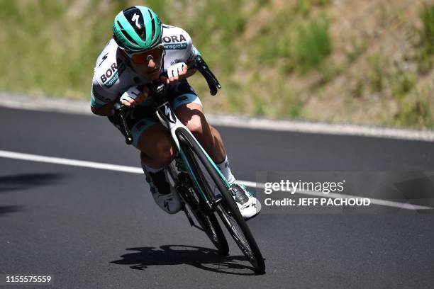 Austria's Lukas Postlberger descends after launching an attack during the ninth stage of the 106th edition of the Tour de France cycling race between...