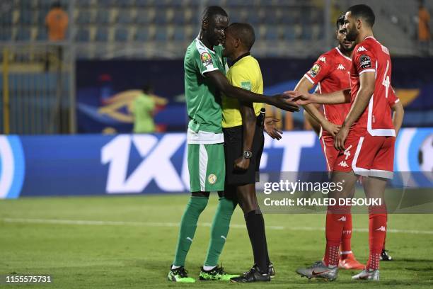 Senegal's defender Cheikhou Kouyate argues with Ethiopian referee Bamlak Tessema Weyesa during the 2019 Africa Cup of Nations Semi-final football...