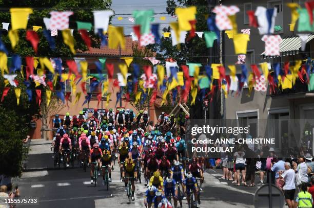 The pack crosses a city during the ninth stage of the 106th edition of the Tour de France cycling race between Saint-Etienne and Brioude, on July 14,...