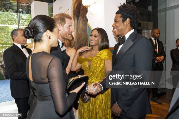 Britain's Prince Harry, Duke of Sussex and Britain's Meghan, Duchess of Sussex meet cast and crew, including US singer-songwriter Beyoncé and her...