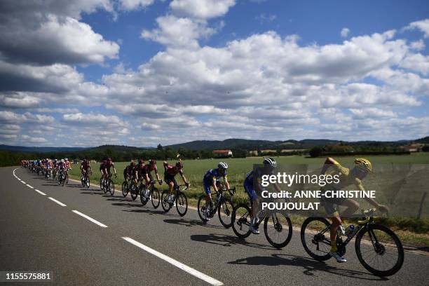 France's Julian Alaphilippe , wearing the overall leader's yellow jersey rides in the pack during the ninth stage of the 106th edition of the Tour de...