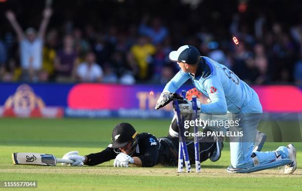 England's Jos Buttler runs out New Zealand's Martin Guptill to win the super-over to win the 2019 Cricket World Cup final between England and New...