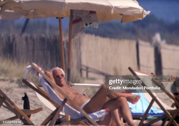 Italian fashion designer Giorgio Armani relaxing at the sea. Sabaudia, 1990s