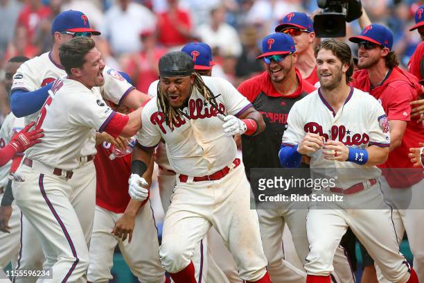 Maikel Franco of the Philadelphia Phillies celebrates with Andrew Knapp, Vince Velasquez, Bryce Harper and Aaron Nola after hitting the game winning...