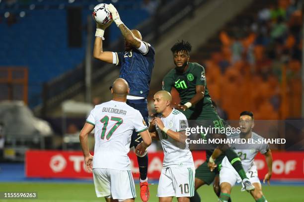 Algeria's goalkeeper Rais M'Bolhi grabs the ball from the air during the 2019 Africa Cup of Nations Semi-final football match between Algeria and...