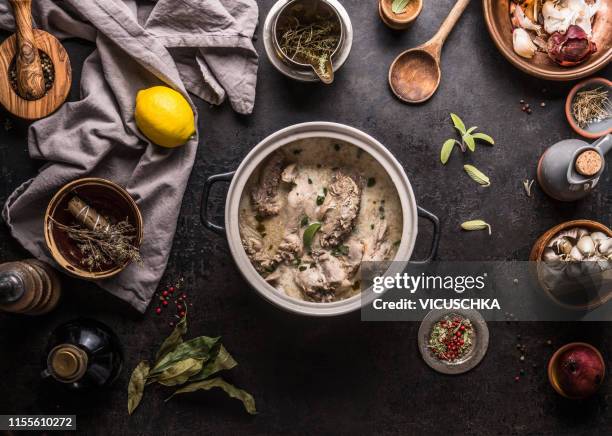 creamy wildfowl ragout or stew in pot on kitchen table with ingredients - comida francesa fotografías e imágenes de stock