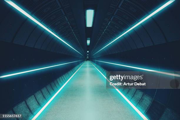 cool underground tunnel with nice vanishing point and neon lights. - diminishing perspective road stock pictures, royalty-free photos & images