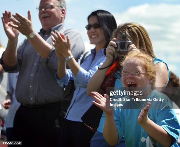 Jerry Holt/Star Tribune 6/17/2004----Special Olympian Abby Hirsch, 10 cheers for teammate Sam LoPresti at the awards stand after he won a metal for...