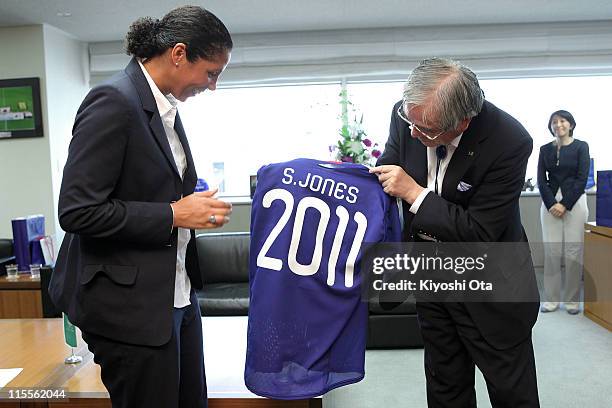 Steffi Jones , President of the Women's World Cup 2011 German Organizing Committee, receives a shirt from Junji Ogura, President of the Japan...