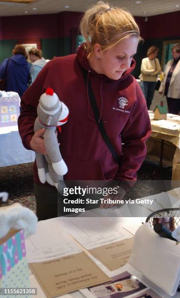 Minneapolis, Mn.,Sat.,April 3, 2004--Jenny Lenz of Minneapolis picked up a sock monkey at the Early Bird Extravaganza, a fund raising event for the...