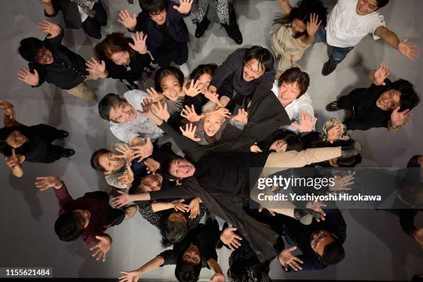 smiling crowd lifting person high from above - japanese bussiness woman looking up stock-fotos und bilder