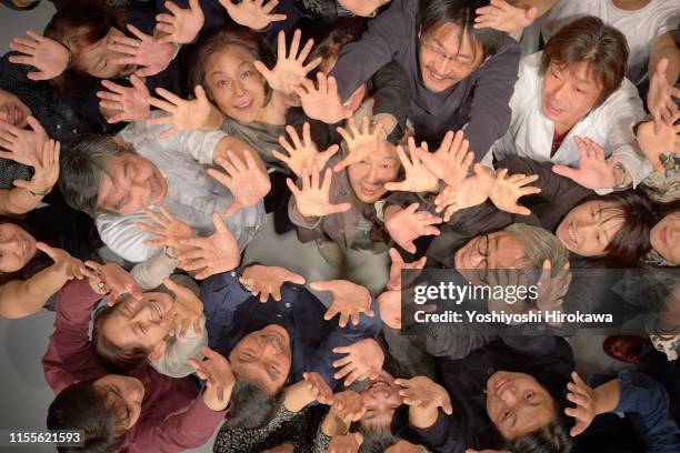 smiling crowd raising arms looking up at the theater from above - japanese bussiness woman looking up imagens e fotografias de stock