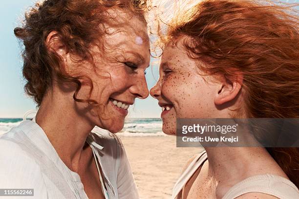 portrait of  mother with daughter, close up - two kids looking at each other stockfoto's en -beelden