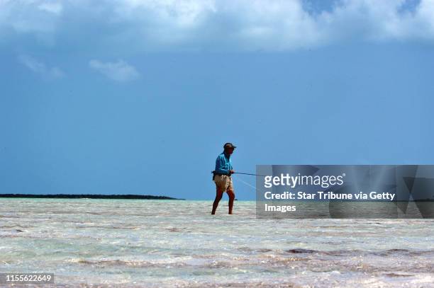 John Marlow of St. Louis, Mo., walks a vast salt water flat in search of bone fish near Georgetown, Exuma, an island in the Bahamas.