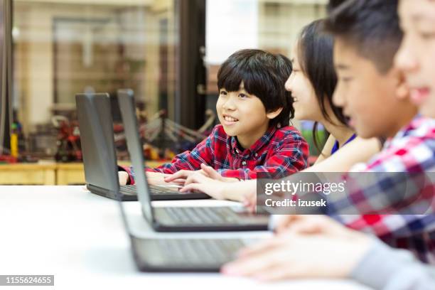students using laptops in programming school - kid coding stock pictures, royalty-free photos & images