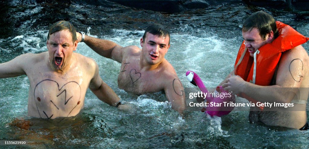 Excelsior, MN., Thursday, 1/1/04. (left to right) John Mugford and brothers Adam Wartman and Tom Wartman reacted to the cold water after jumping into a hole cut in the ice at Lake Minnetonka. The trio from Excelsior were amoung the four hundred people